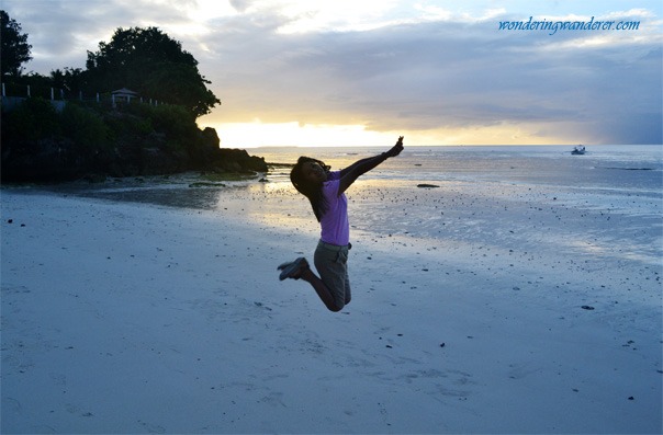 Woman jumping in Alona Beach Bohol